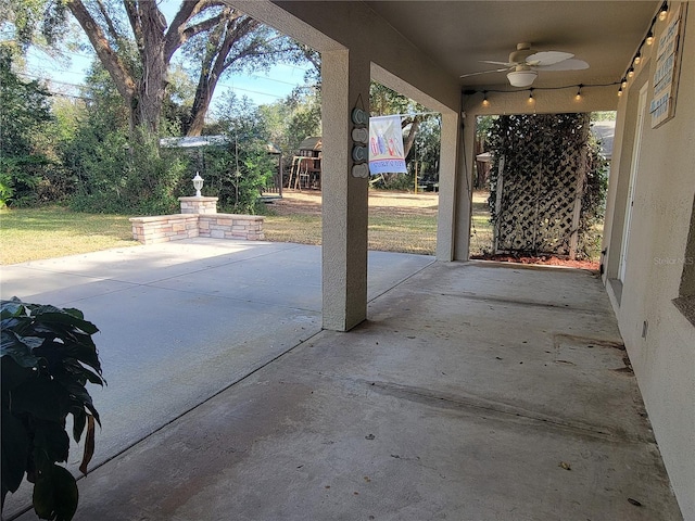 view of patio featuring ceiling fan and a playground