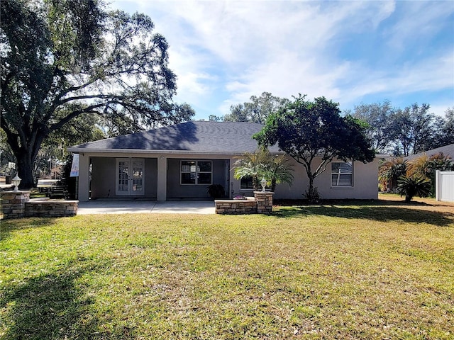 back of house with a yard and a patio area