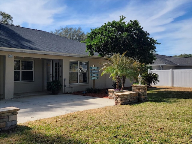 rear view of house with a yard