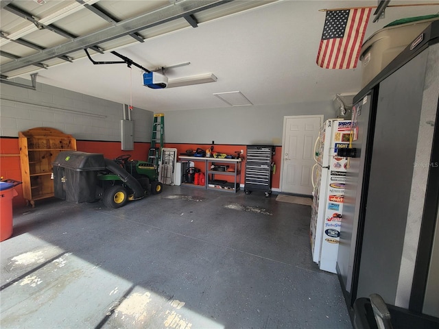 garage with a garage door opener and electric panel