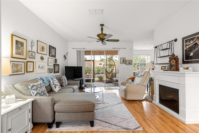 living room featuring ceiling fan and light wood-type flooring