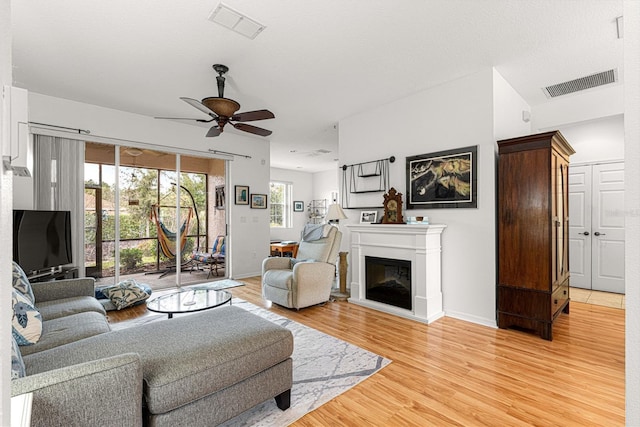 living room featuring light hardwood / wood-style floors and ceiling fan