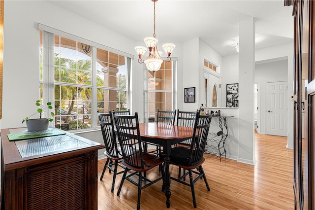 dining space featuring a chandelier and light hardwood / wood-style floors