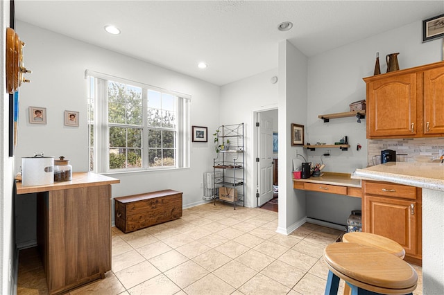 kitchen with decorative backsplash and light tile patterned floors