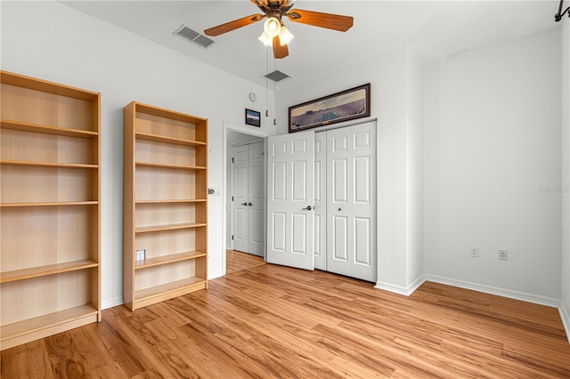 unfurnished bedroom with a closet, ceiling fan, and light hardwood / wood-style floors