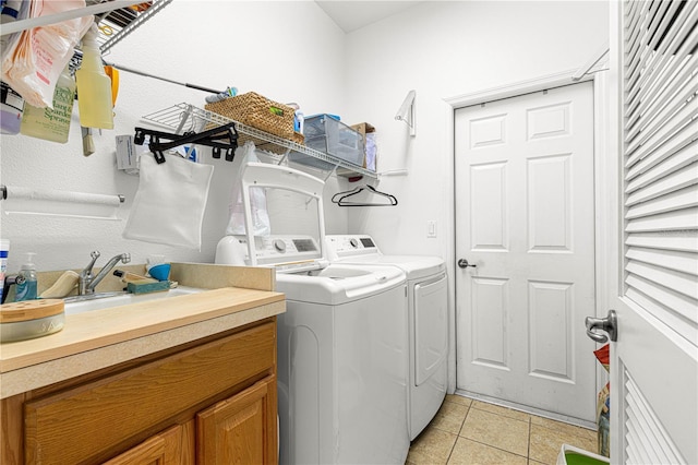 laundry room featuring washer and dryer and light tile patterned floors