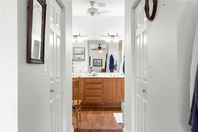 bathroom featuring vanity, wood-type flooring, and ceiling fan