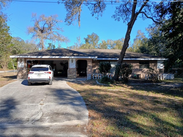 ranch-style home with a garage and a front lawn