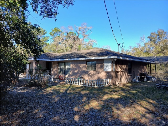 rear view of house featuring a lawn