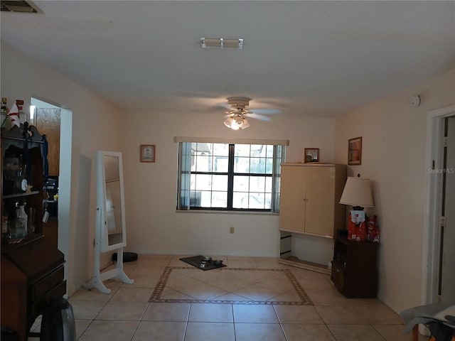 tiled entryway with ceiling fan