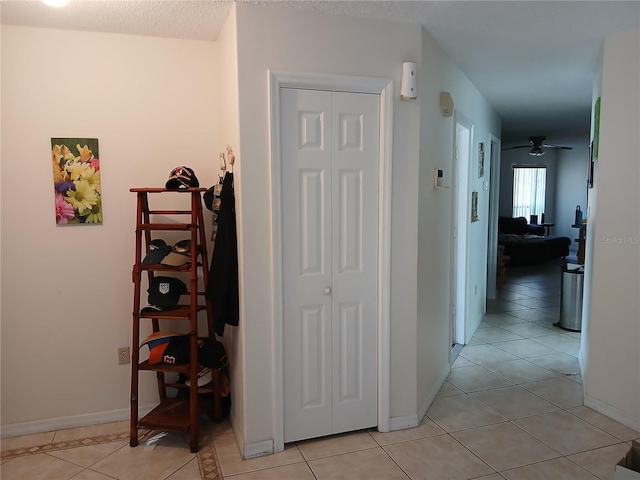 corridor featuring light tile patterned floors