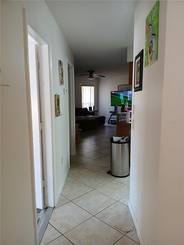 hall with light tile patterned floors