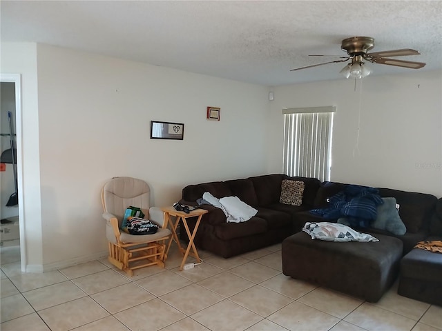 tiled living room with ceiling fan and a textured ceiling