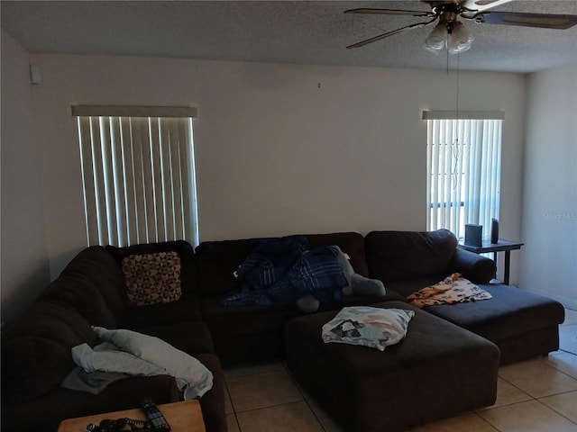 tiled living room featuring ceiling fan and a textured ceiling