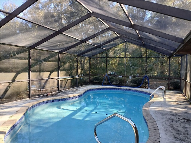 view of swimming pool with a lanai and a patio area