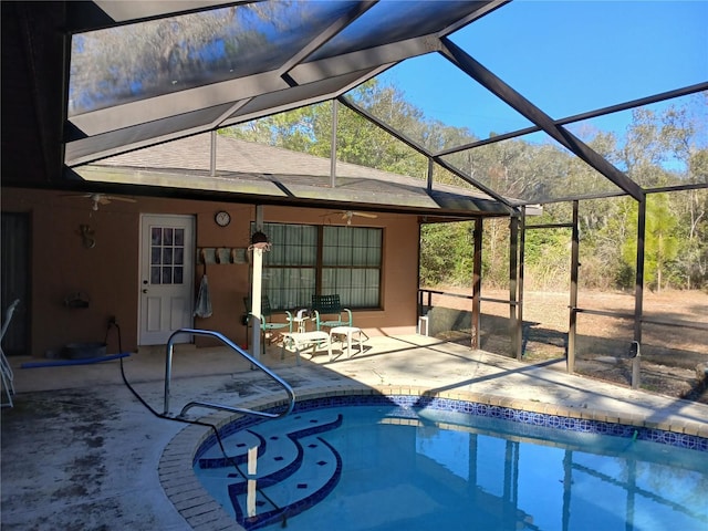 view of pool featuring a lanai, ceiling fan, and a patio area