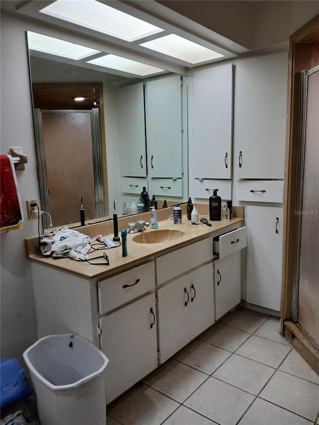 bathroom with vanity, an enclosed shower, and tile patterned flooring