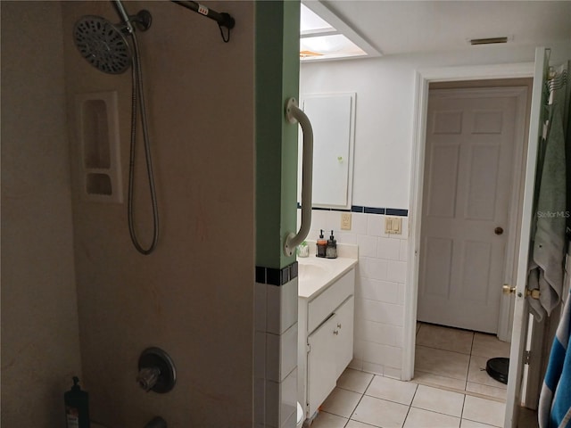 bathroom with vanity, tile patterned floors, and tile walls