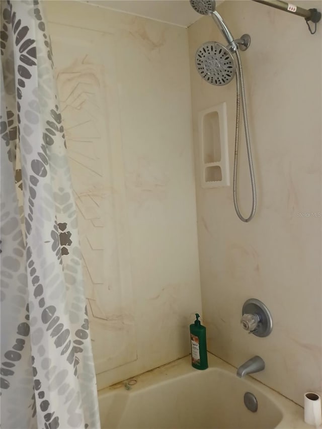 bathroom with shower / bath combination with curtain