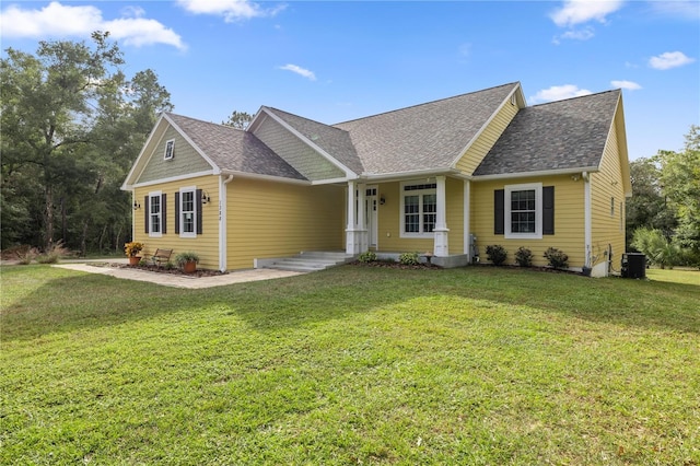 view of front of property featuring cooling unit and a front lawn