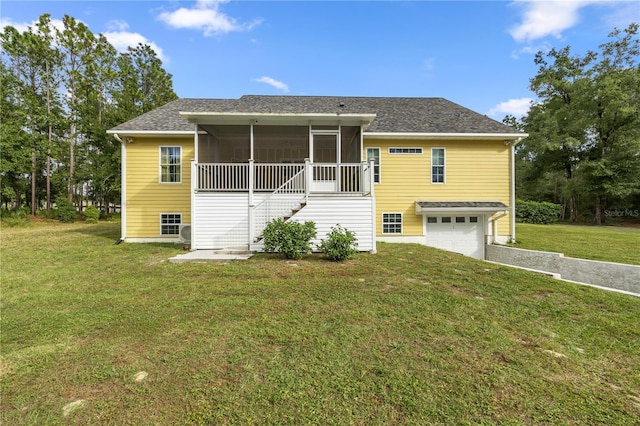 view of front facade featuring a garage, a sunroom, and a front yard