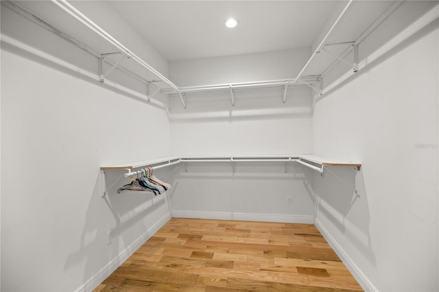 walk in closet featuring hardwood / wood-style flooring