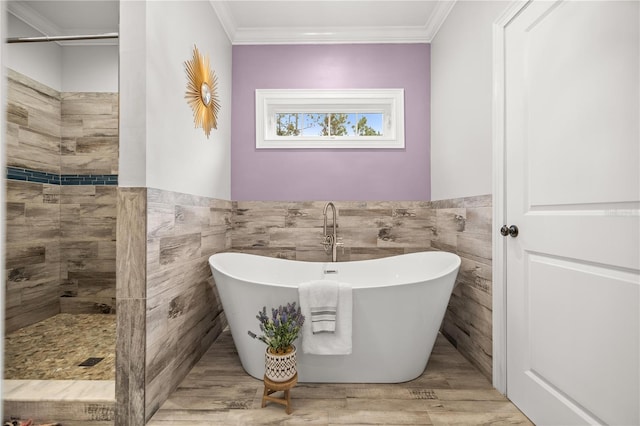 bathroom with tile walls, wood-type flooring, ornamental molding, and separate shower and tub