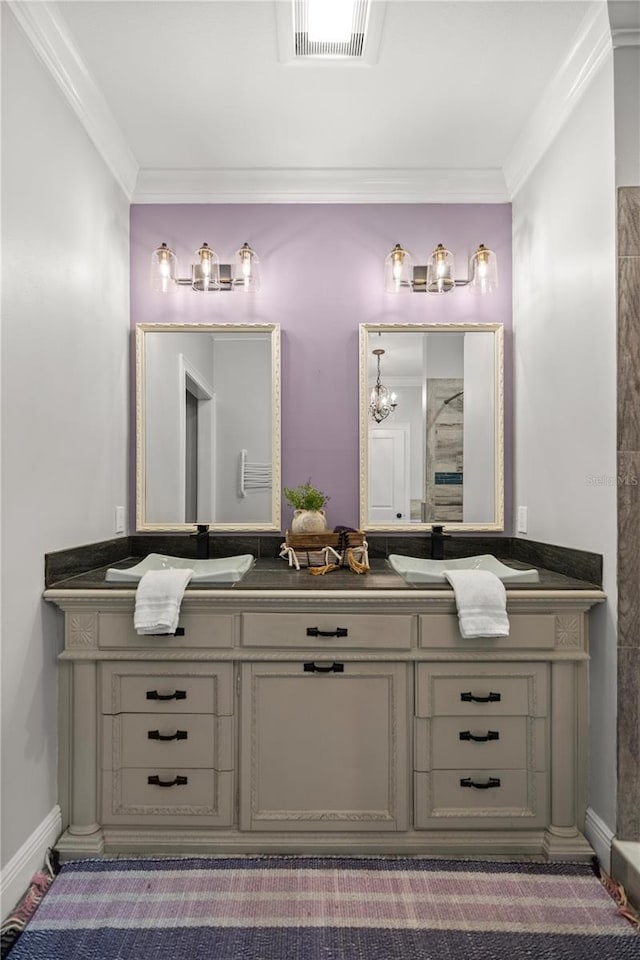 bathroom with crown molding and vanity