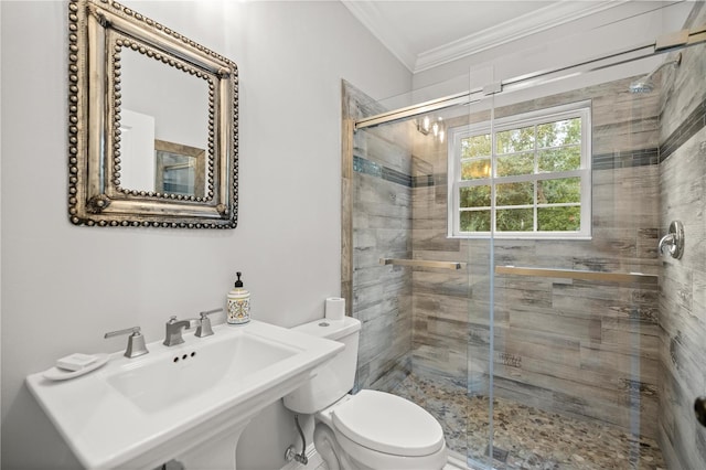 bathroom with ornamental molding, toilet, a shower with shower door, and sink