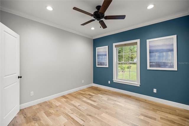 spare room with ornamental molding, ceiling fan, and light wood-type flooring