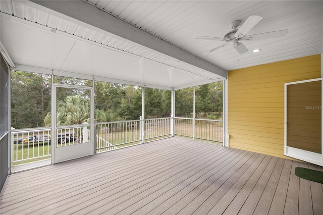 unfurnished sunroom featuring ceiling fan