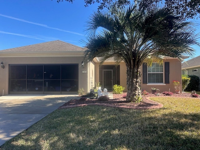 ranch-style home featuring a garage, a front yard, concrete driveway, and stucco siding