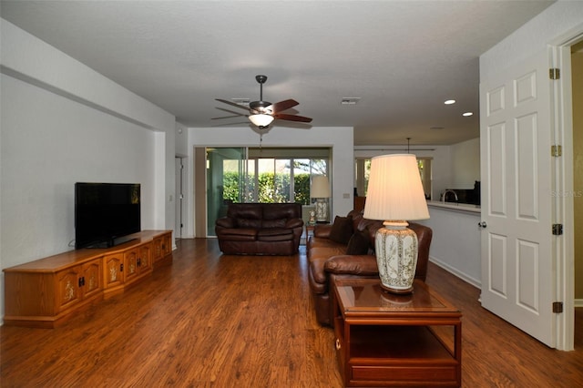 living room with ceiling fan and hardwood / wood-style floors