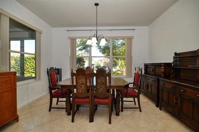 tiled dining area featuring plenty of natural light and a chandelier