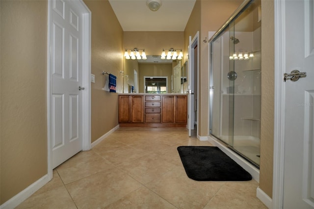 bathroom featuring an enclosed shower, vanity, and tile patterned flooring