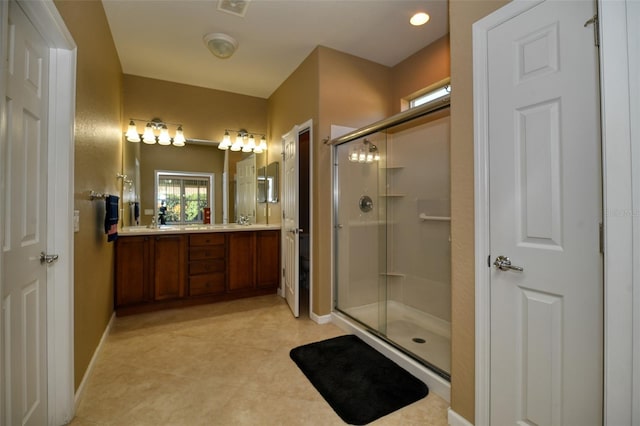 bathroom featuring vanity, tile patterned flooring, and a shower with shower door