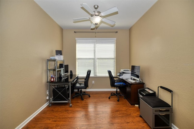 home office featuring dark hardwood / wood-style flooring and ceiling fan