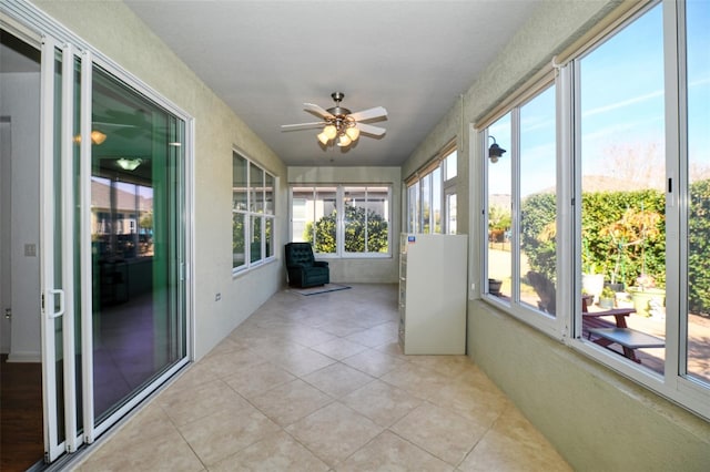 unfurnished sunroom featuring ceiling fan