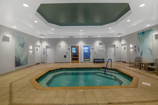 view of pool with elevator and an indoor in ground hot tub