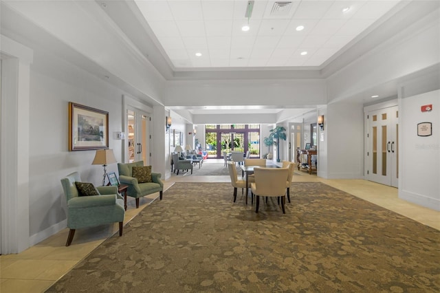 dining space featuring a towering ceiling and french doors