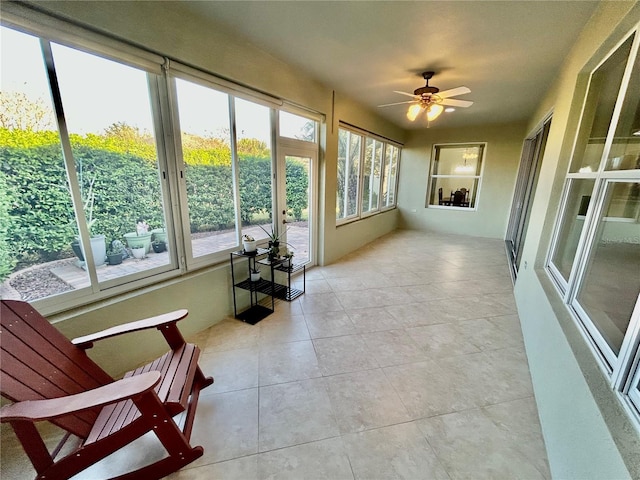 sunroom / solarium featuring ceiling fan