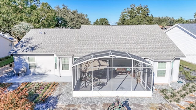 rear view of property with a lanai and a patio area