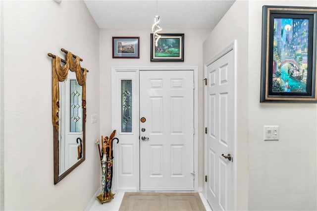 entryway with a textured ceiling