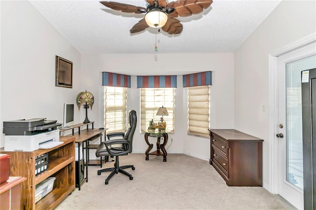 office featuring ceiling fan, light carpet, and a textured ceiling