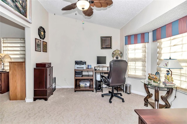 home office featuring ceiling fan, lofted ceiling, carpet, and a textured ceiling