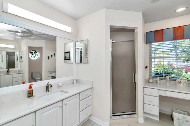 bathroom with tile patterned flooring, vanity, an enclosed shower, and toilet