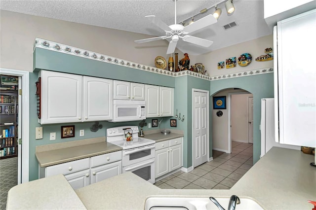 kitchen with ceiling fan, white appliances, white cabinets, and light tile patterned flooring