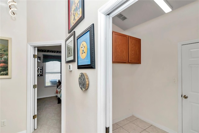 hall featuring light tile patterned flooring