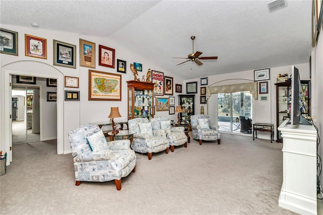 3923 Manor Oaks Ct, Leesburg, FL 34748 - carpeted living room with lofted ceiling, ceiling fan, and a textured ceiling