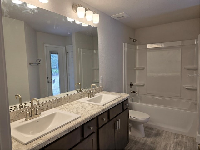 full bathroom featuring vanity, toilet, bathing tub / shower combination, and hardwood / wood-style floors